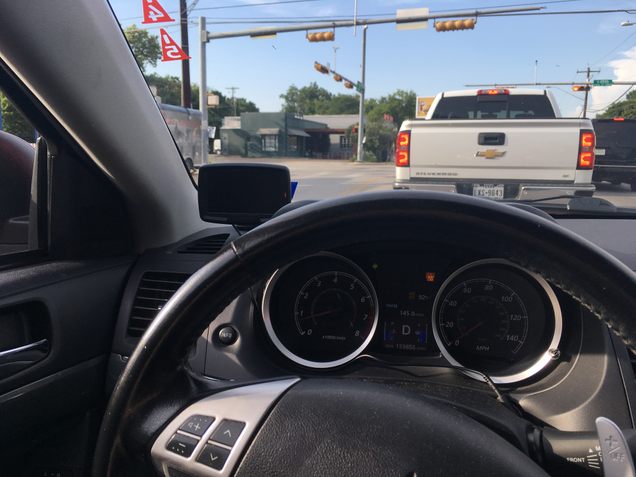 The CS-2 tucks neatly in the corner of my 2010 Mitsubishi Lancer’s dashboard. Tucking the wire out of the way is a much more difficult proposition. (Yes, I know the “service engine soon” light is on.)